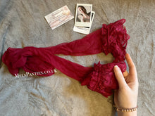 Load image into Gallery viewer, A pair of worn burgundy stockings