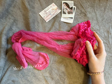 Load image into Gallery viewer, A pair of worn pink stockings